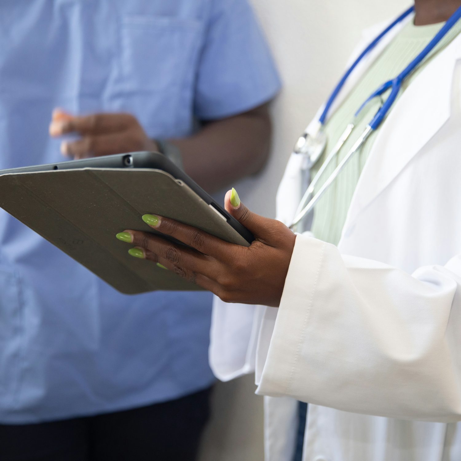 Clinical staff reviewing data on a tablet